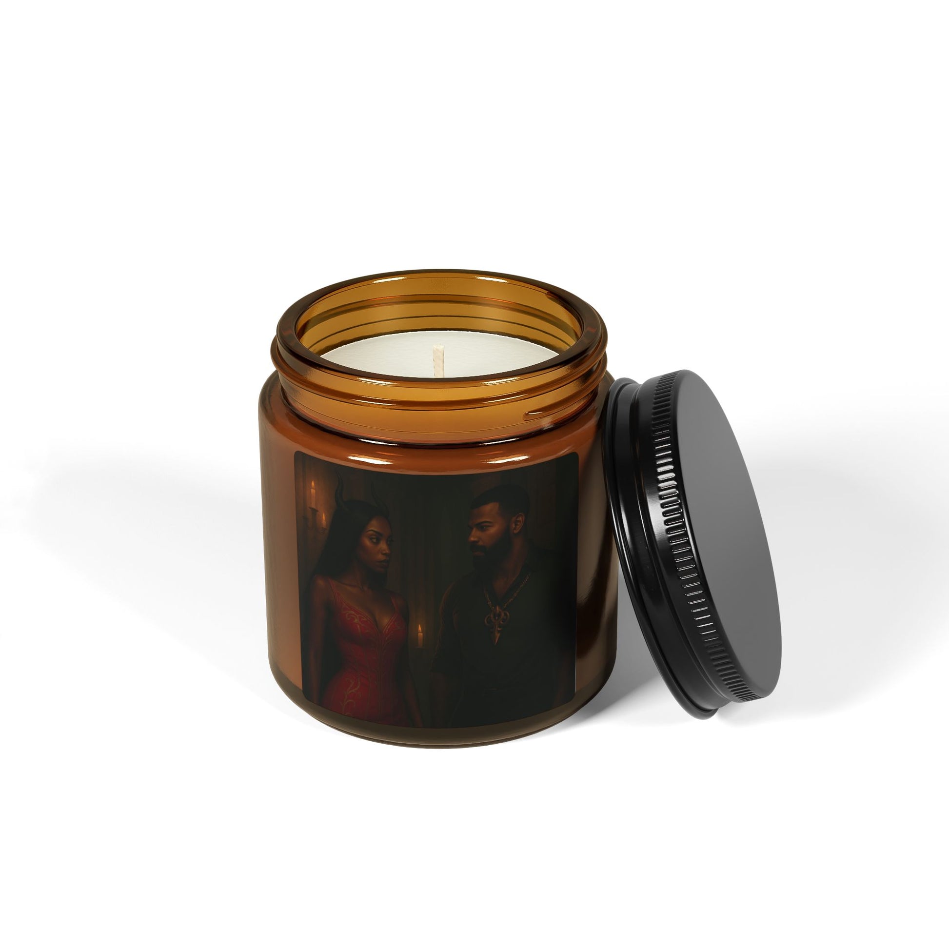 Candle in an amber jar with a black lid on a white background
