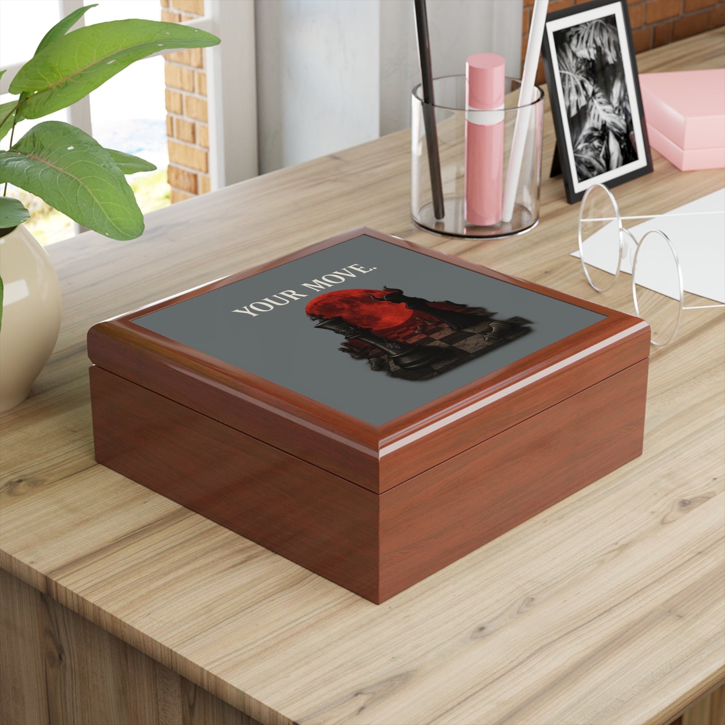 Wooden box with a blood moon chess board design on a wooden surface