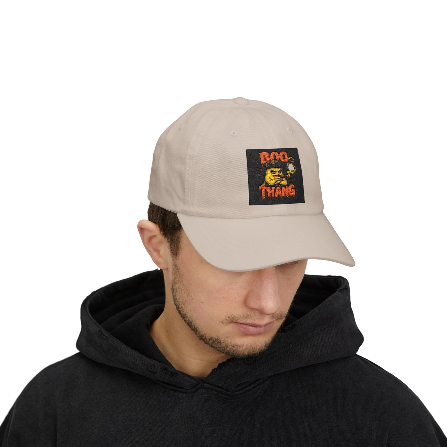 Man wearing a beige cap with a 'Boo Thang' patch on a white background