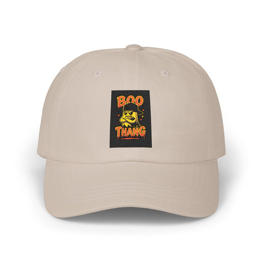 Beige cap with a graphic patch featuring text and a face design on a white background