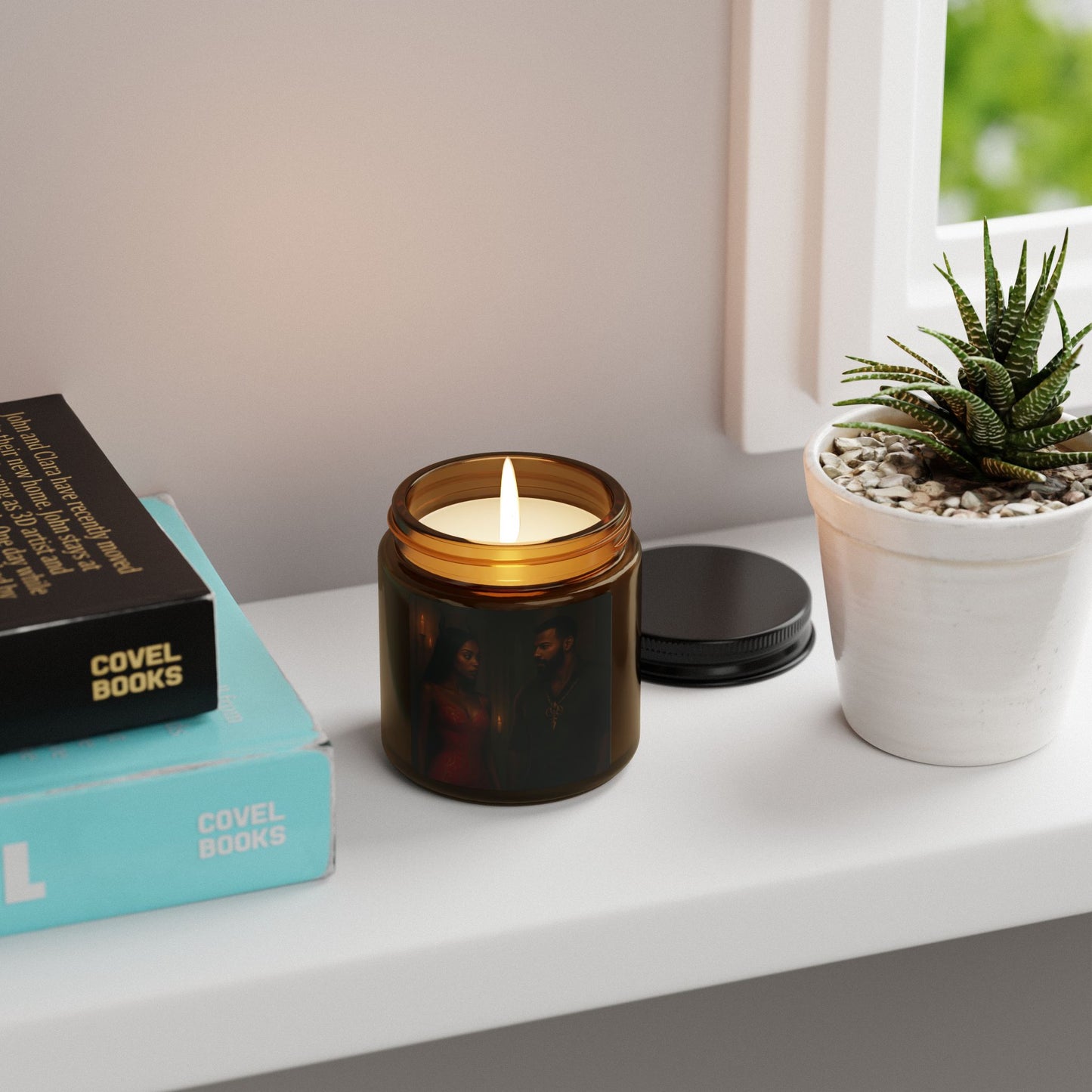 Candle in a tortoiseshell-patterned jar on a shelf with books and a plant