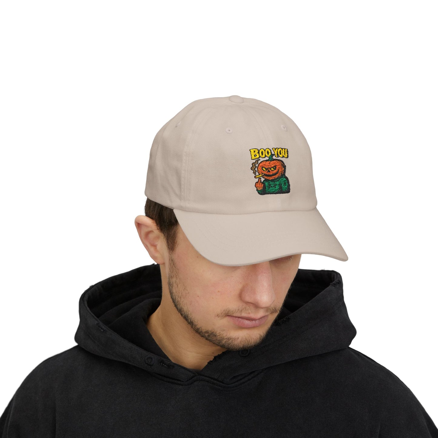 Man wearing a beige cap with a Halloween-themed design on a white background