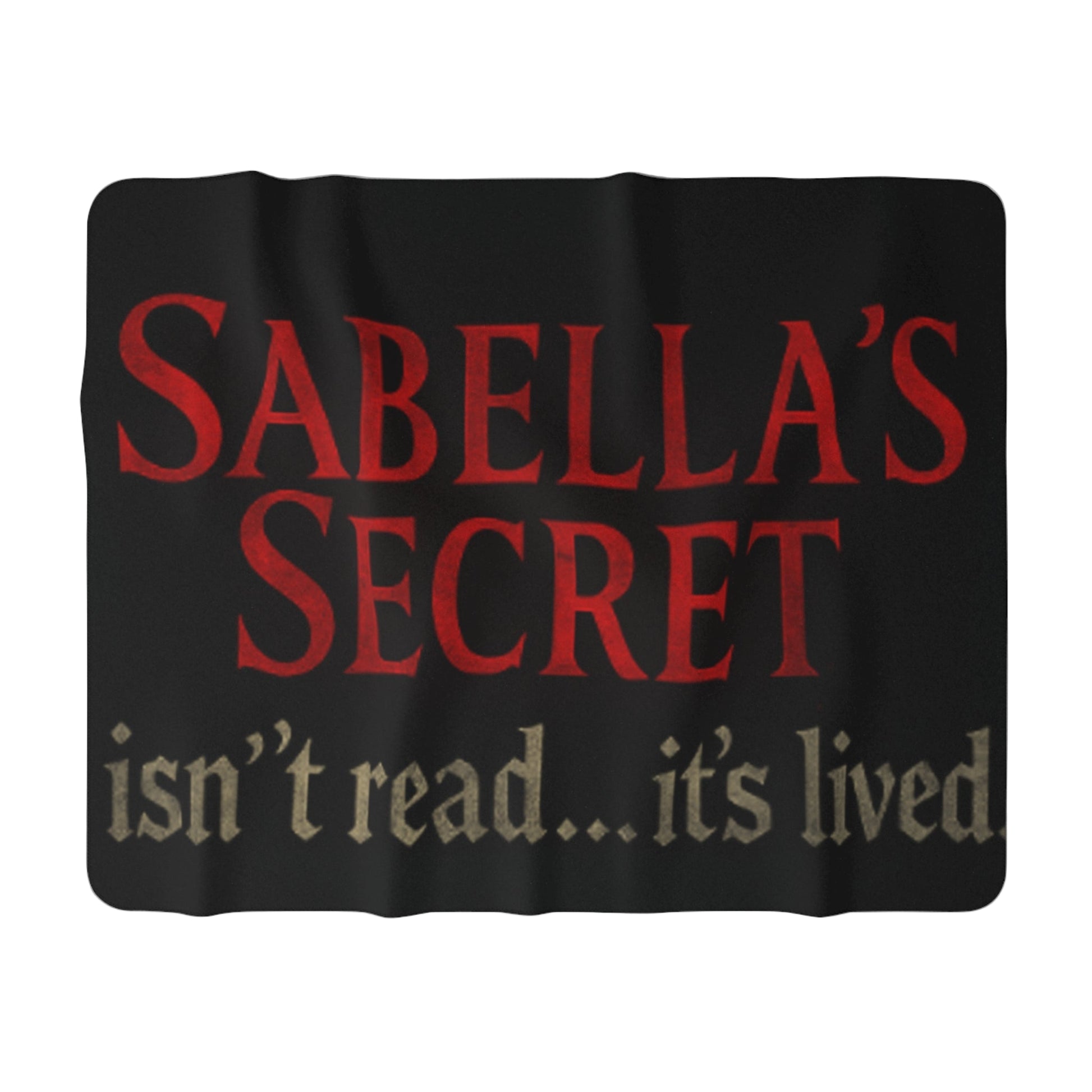 Black blanket with red and white text 'SABELLA'S SECRET isn't read... it's lived' on a white background