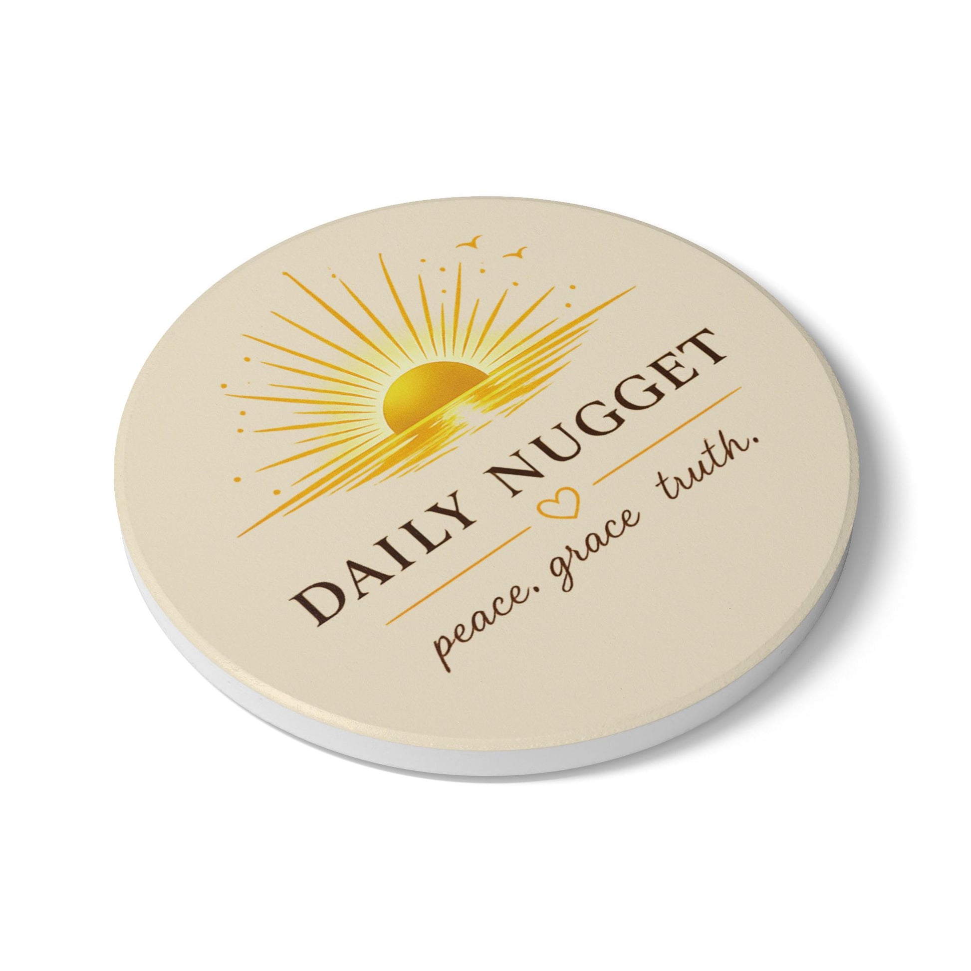 "Daily Nugget ceramic coaster with golden sunrise and 'peace. grace. truth.' quote — Grace Out Loud collection" slant view