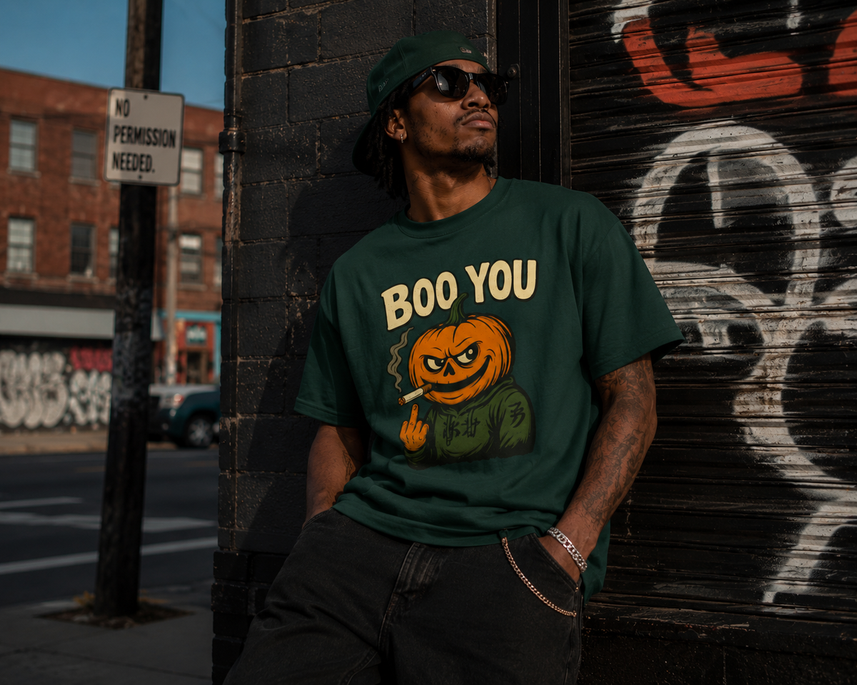 Forest Green (man, sunglasses, No Permission Needed sign, graffiti shutter) — "Man in forest green Boo You Stank Statement Tee with sunglasses leaning against a graffiti-covered shutter next to a No Permission Needed street sign, urban street style"