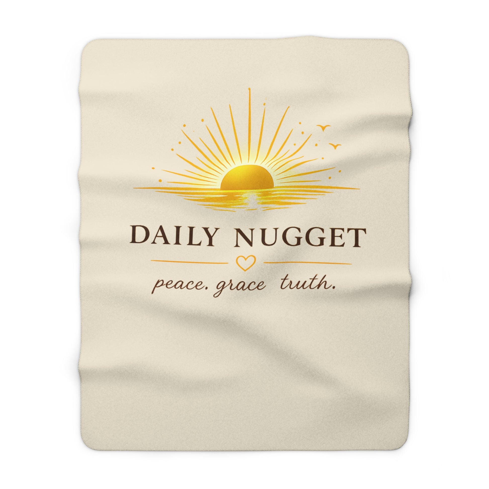 "Sherpa fleece blanket with golden sunrise motif and 'peace. grace. truth.' text on a warm cream background — Daily Nugget Grace Out Loud collection"