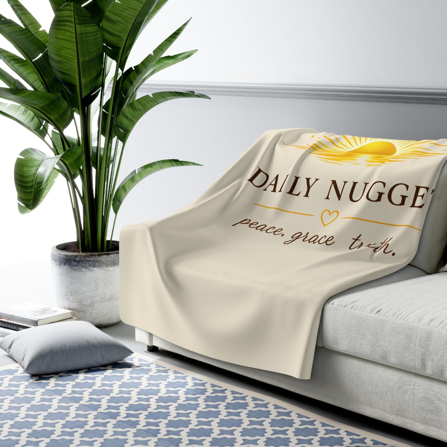 Sherpa fleece blanket with golden sunrise motif and 'peace. grace. truth.' text on a warm cream background  live folded
