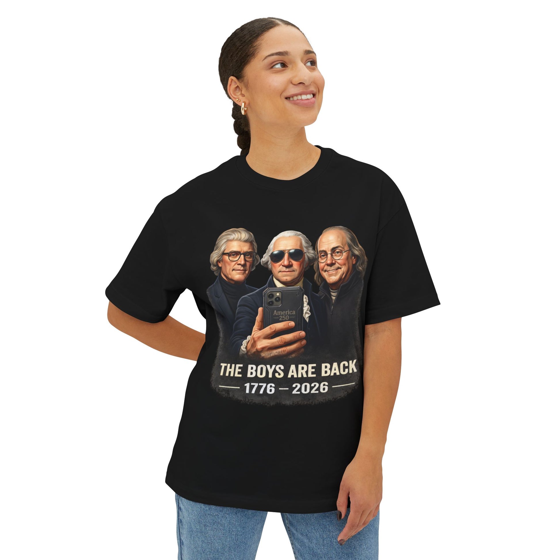 Female wearing a black t-shirt with a graphic of three historical figures and text 'The Boys Are Back 1776-2028'.