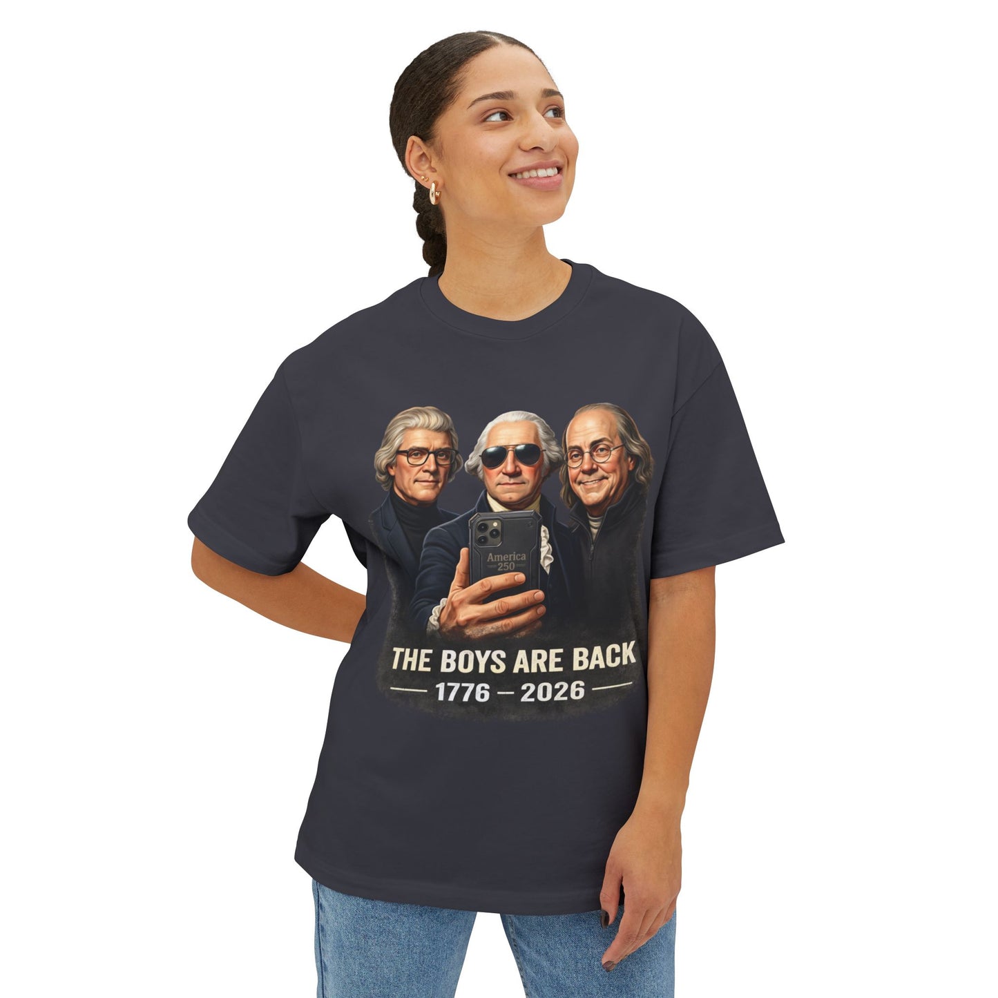 Female wearing a Graye t-shirt with a graphic of three historical figures and text 'The Boys Are Back 1776-2026' on a white background.